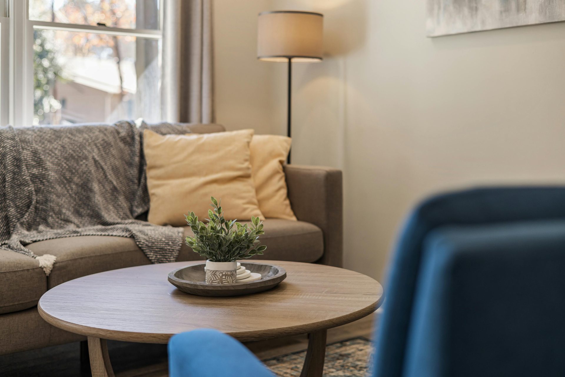 A stylish living room with a cozy couch, armchair, and decor enhancing the modern vibe.